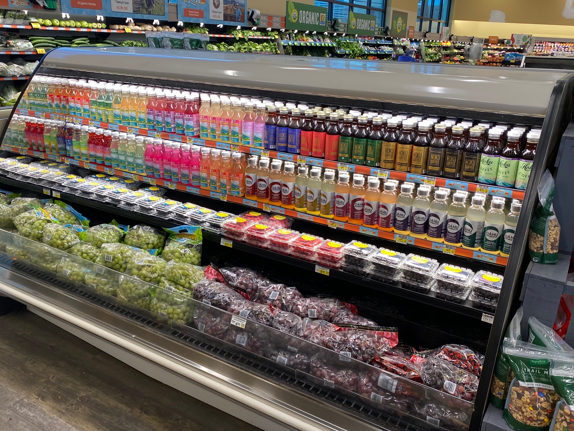 Oahu Kombucha bottles lined up on a refrigerated shelf at Safeway Beretania